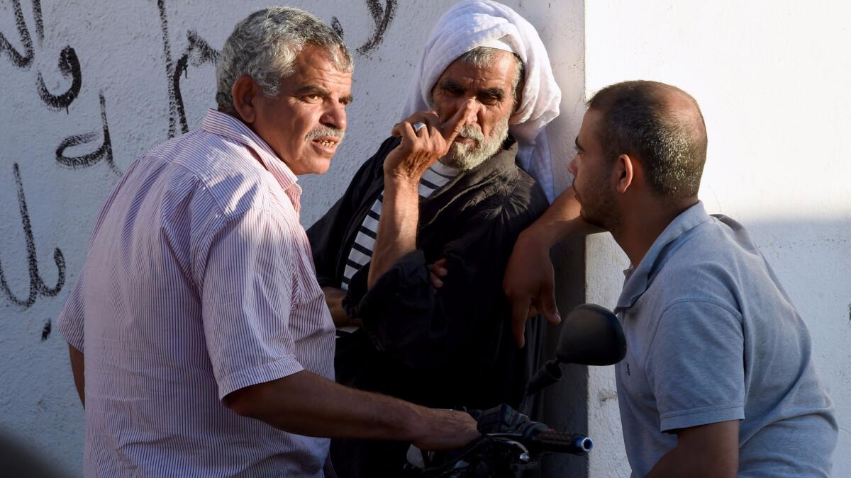 Neighbors gather outside the family home of Mohamed Lahouaiej Bouhlel, in the northeastern Tunisian town of Msaken, on July 15, 2016.