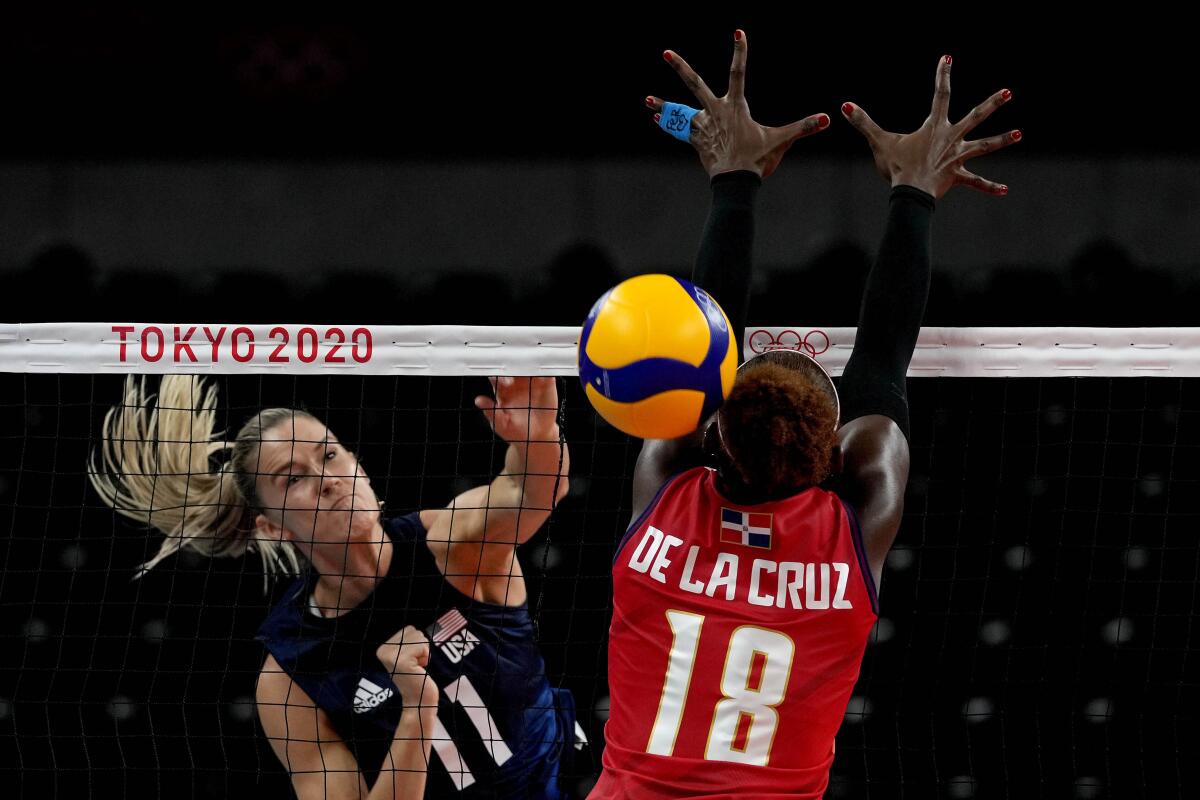 Andrea Drews spikes the volleyball past the Dominican Republic's Bethania de la Cruz de Pena at the Tokyo Olympics.