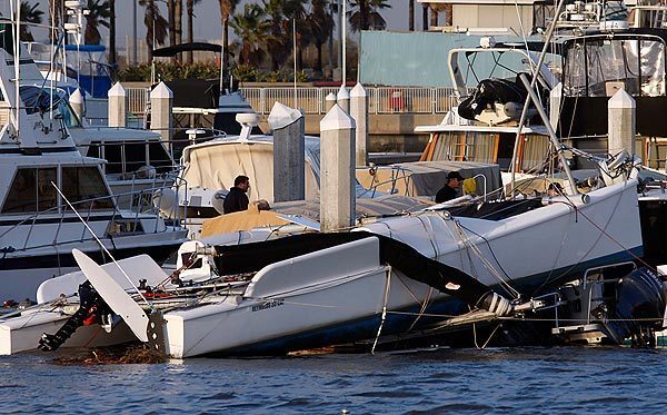 A catamaran is askew on a dock in the Huntington Harbour area, which a tornado reportedly passed through.