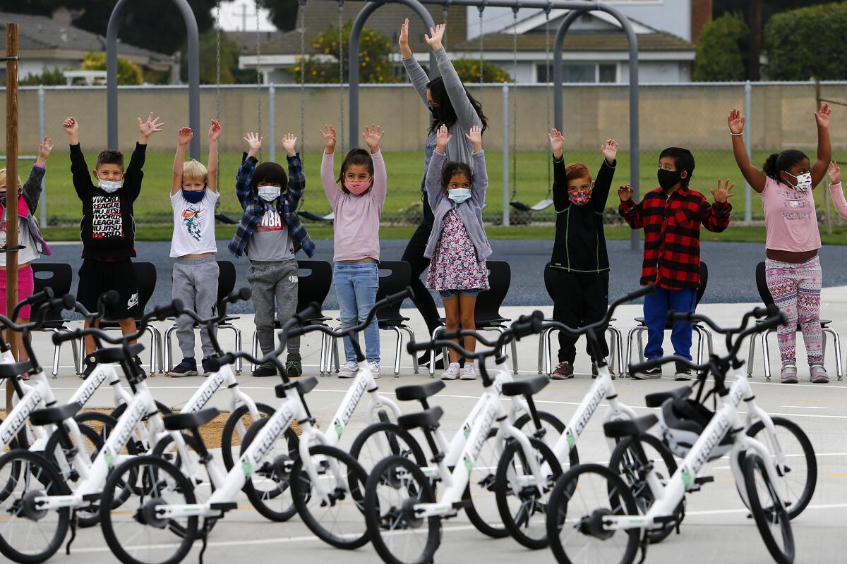 Kindergarten students stand Thursday as they check out 24 Strider bikes which have been donated to College View Elementary.