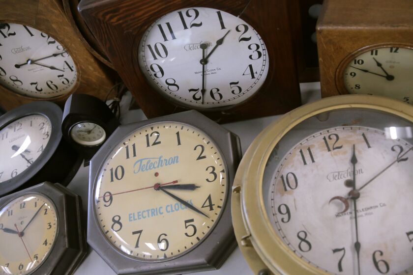 In this Thursday, March 5, 2020, photo, antique clocks are displayed at the Electric Time Company, in Medfield, Massachusetts. Most Americans will lose an hour of sleep this weekend, but gain an hour of evening light for months ahead, as Daylight Saving Time returns this weekend. The time change officially starts Sunday at 2 a.m. local time. (AP Photo/Charles Krupa)