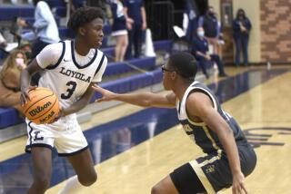 Loyola's Jalen Cox (left) goes against St. Francis' Jackson Mosley.