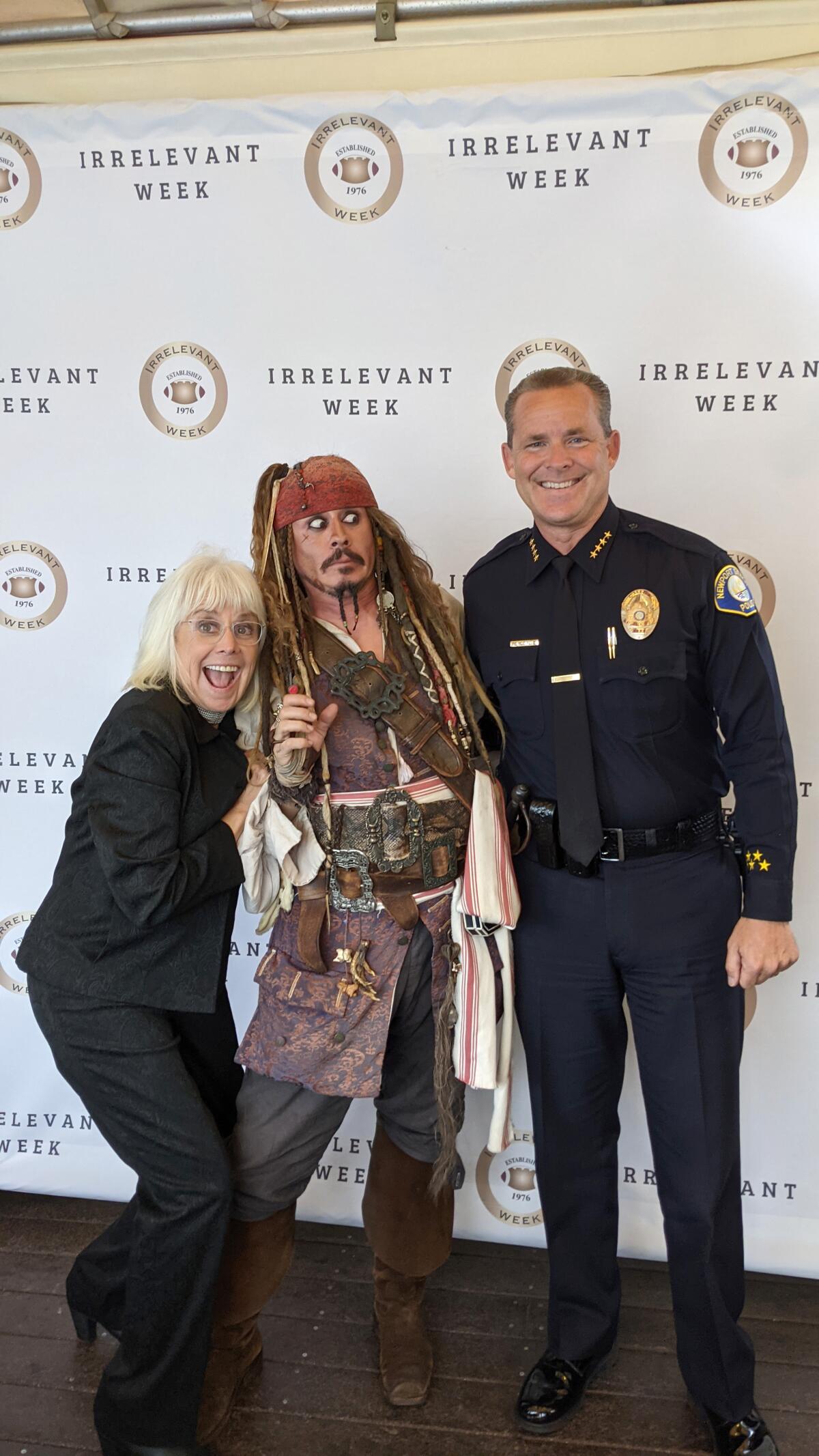Irrelevant Week chairman Melanie Fitch, "Jack Sparrow" and Police Chief John Lewis at Irrelevant Week banquet.