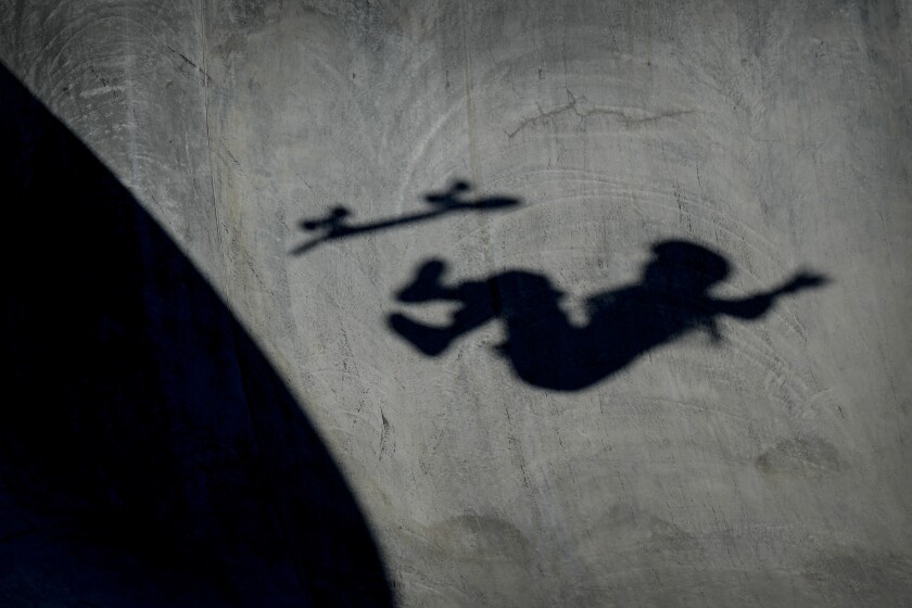 A skateboarder's shadow is seen on the concrete