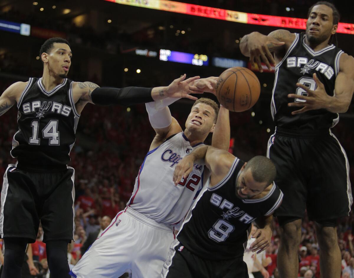 Clippers forward Blake Griffin is triple teamed by Spurs guard Danny Green (14), guard Tony Parker (9) and forward Kawhi Leonard (2).