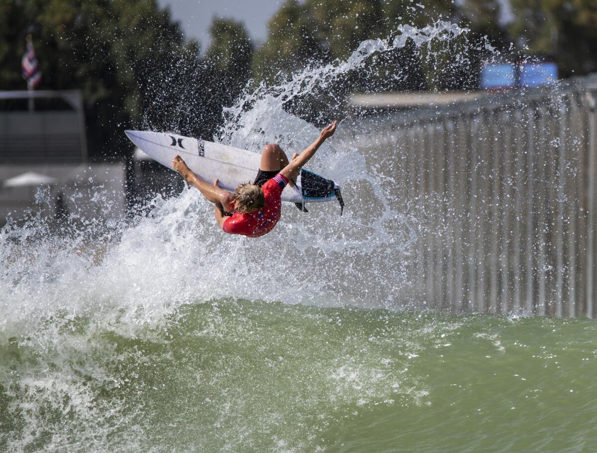 John John Florence, of Hawaii, who is a 2017 World Surf League men's champion, does an aerial over the machine-groomed wave during practice with Team U.S.A.