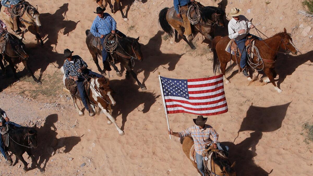 The Bundy family and their supporters fly the American flag as their cattle are released by the Bureau of Land Management back onto public land outside of Bunkerville, Nev., in 2014.