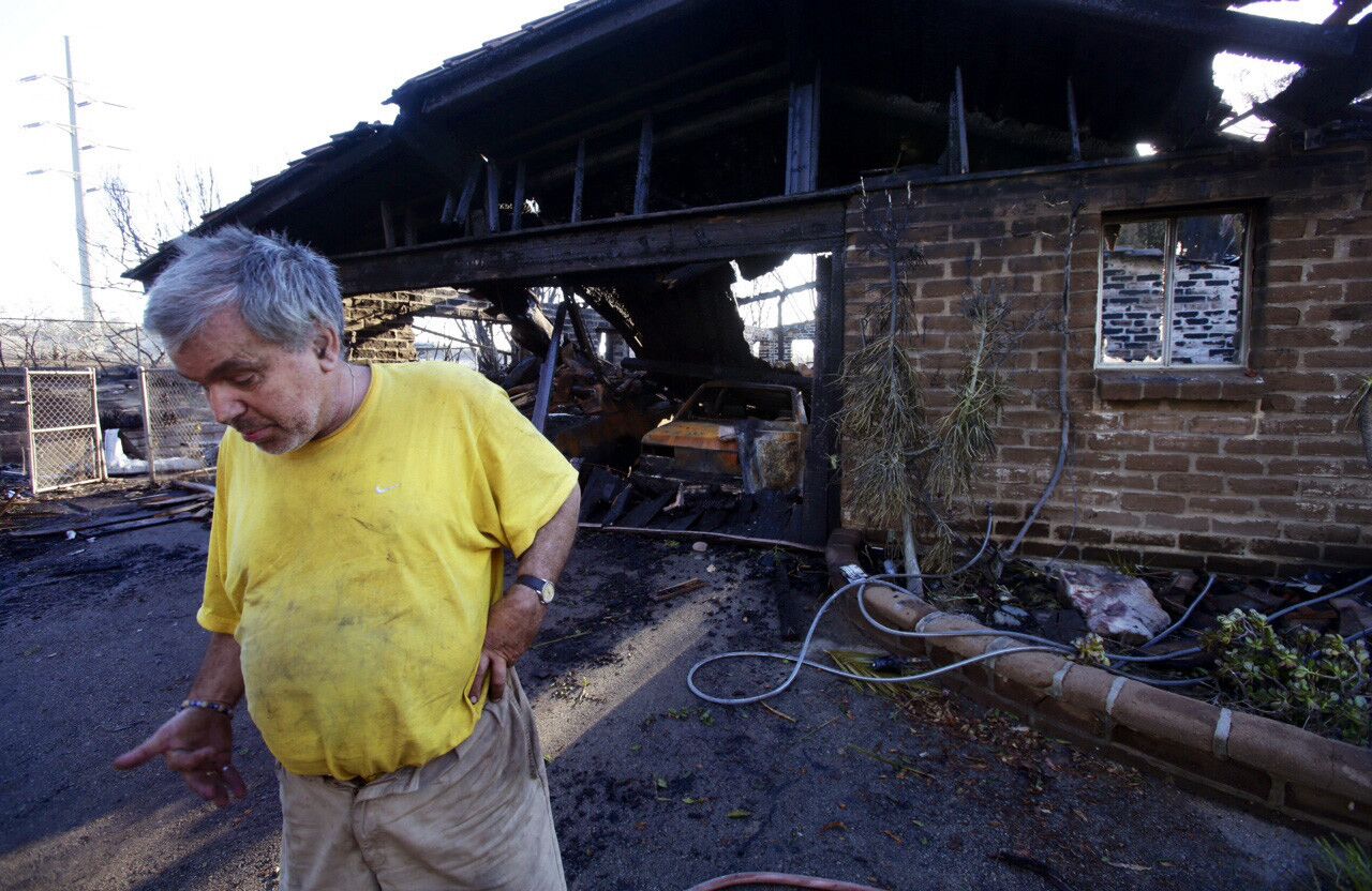 Gregory Saska, 63, surveys his destroyed home in the 1700 block of Skimmer Court in Carlsbad.