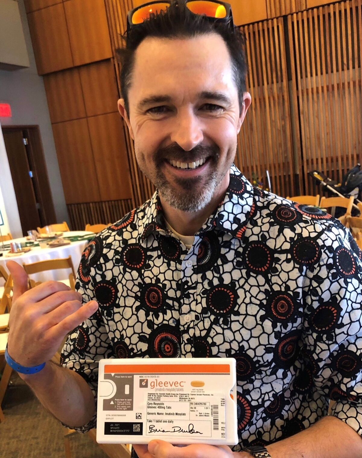 Cory Reynolds poses with his autographed prescription at this year’s ‘Surfing For a Cure’ Luau and Legends of Surfing Invitational, Aug. 17.