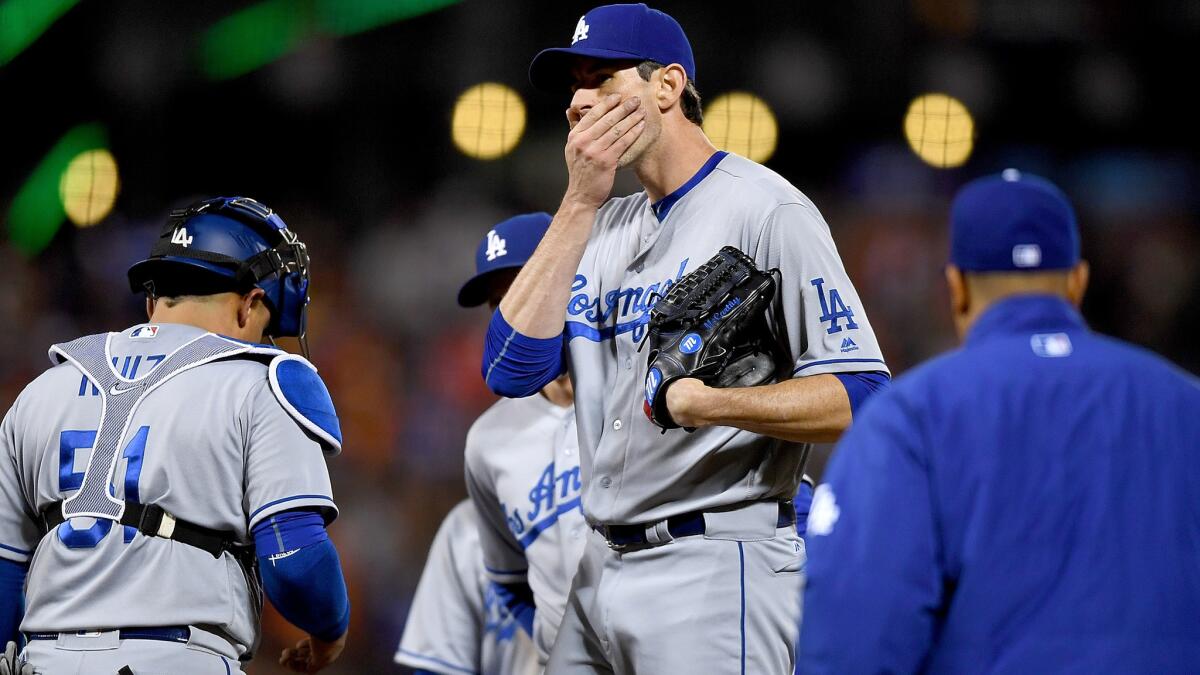 Dodgers reliever Brandon McCarthy is removed from the game after giving up six runs on five hits to the Giants without recording an out in the sixth inning Friday night.
