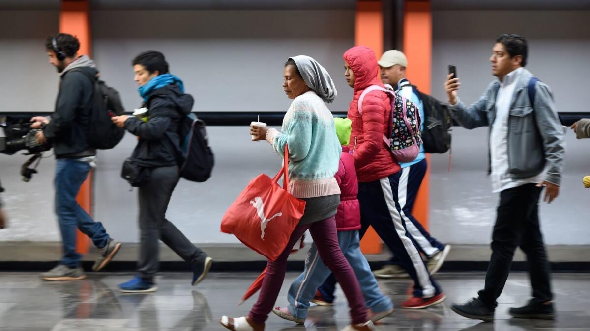 A group of Central American migrants heading in a caravan to the U.S. at the Ciudad Deportiva metro station in Mexico City, on their way to Queretaro state.