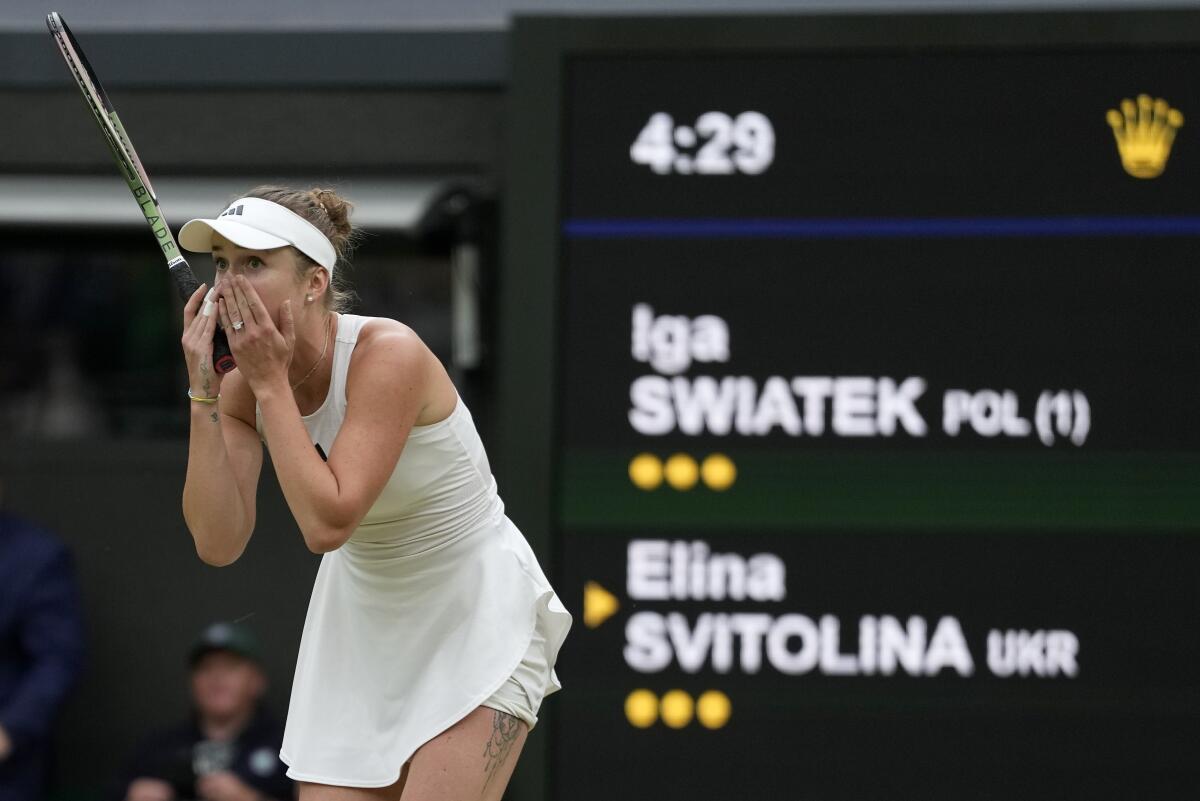 Tennis player Elina Svitolina holds her hands to her face at Wimbledon.