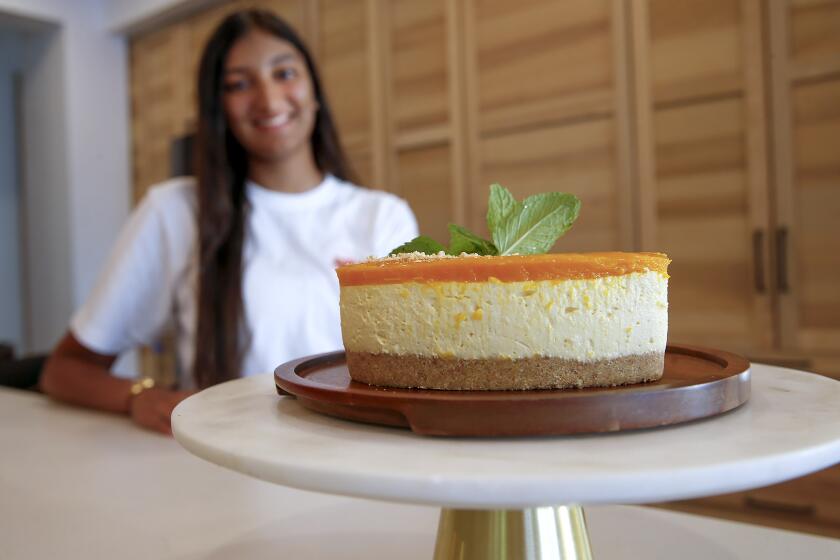 Sage Hill senior Shiksha Anand with her popular Mango cheesecake at her home in Newport Beach. Shiksha started her own baking company called Penplatter in 2021 and and cultivated her baking talent in March 2020. Anand currently sells her baked goods through online and in-person fair orders.