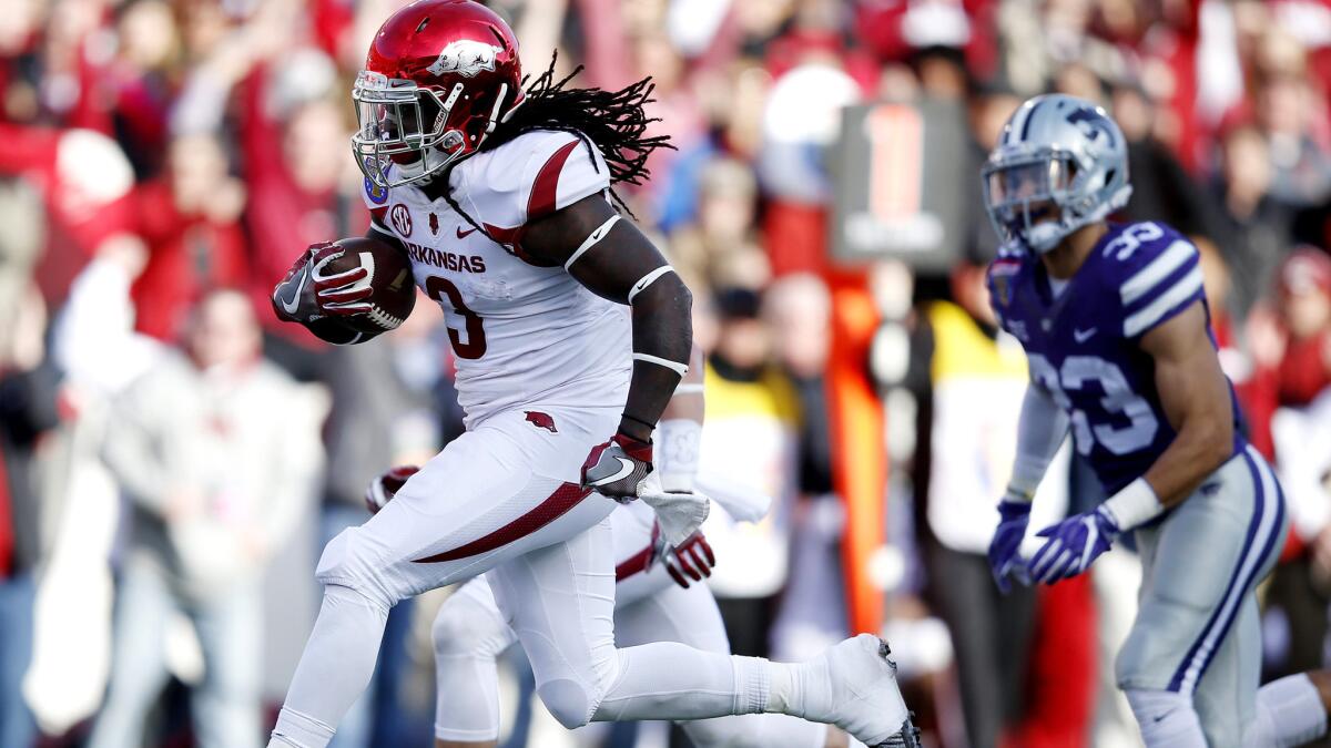 Arkansas running back Alex Collins breaks free on a 22-yard touchdown run against the Kansas State in the first quarter of the Liberty Bowl.