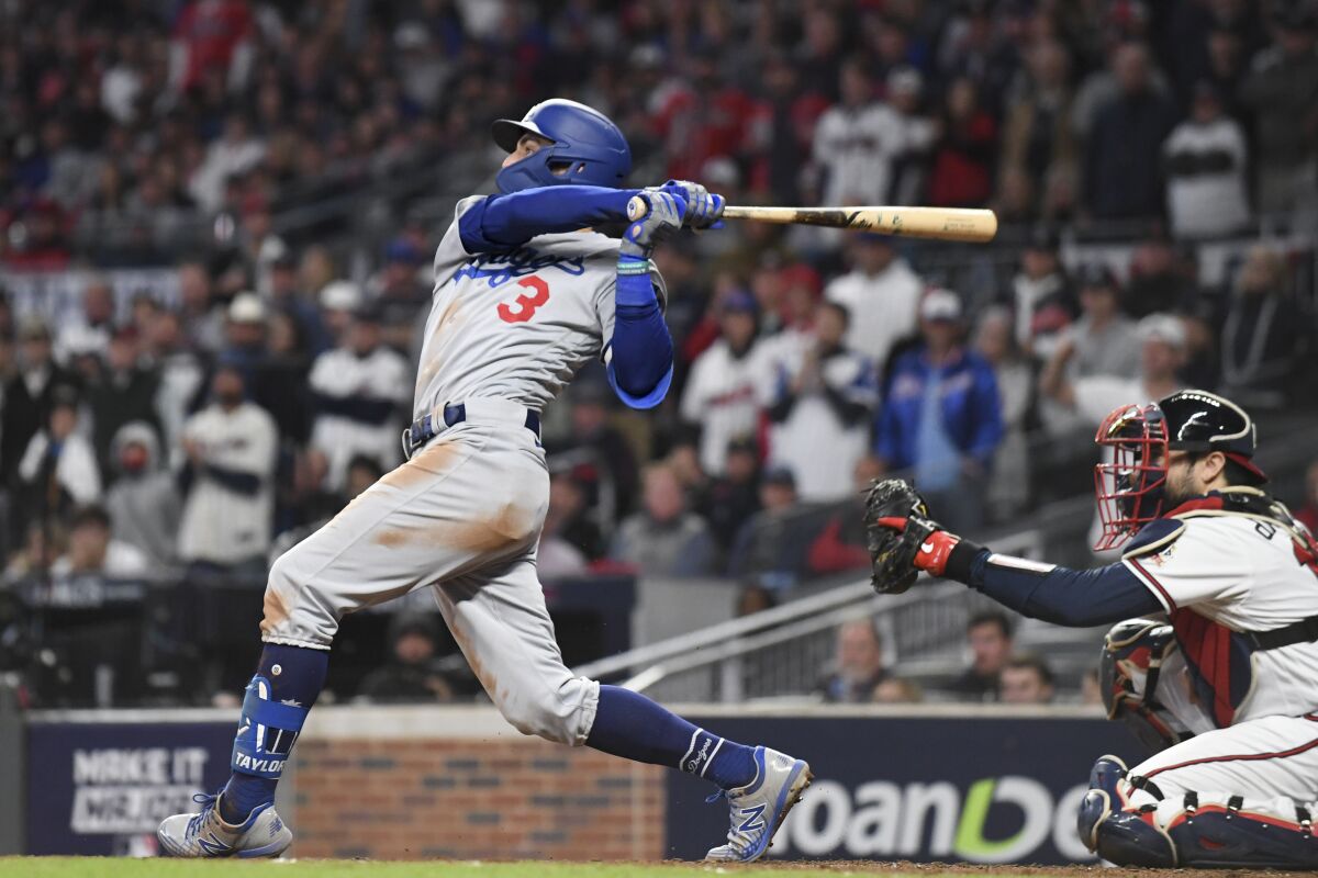Dodgers' Chris Taylor follows through on a swing for a go-ahead two-run double.