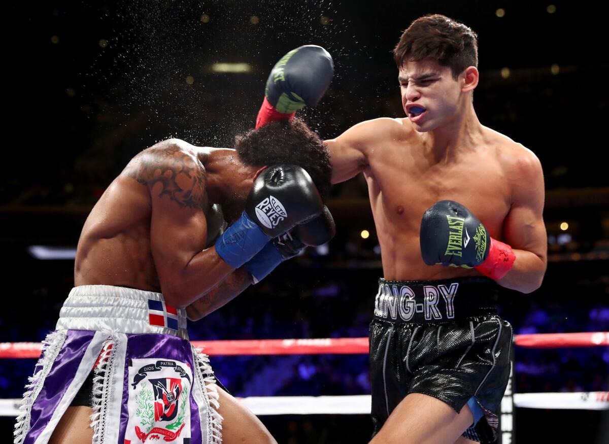 Ryan Garcia, right, lands a punch in the boxing ring against Braulio Rodriguez