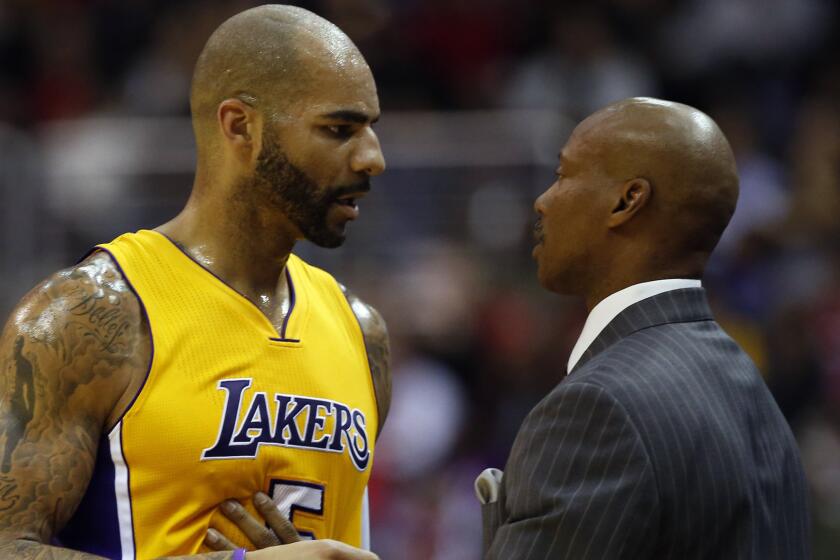 Lakers forward Carlos Boozer speaks with Coach Byron Scott during a loss to the Washington Wizards last week.