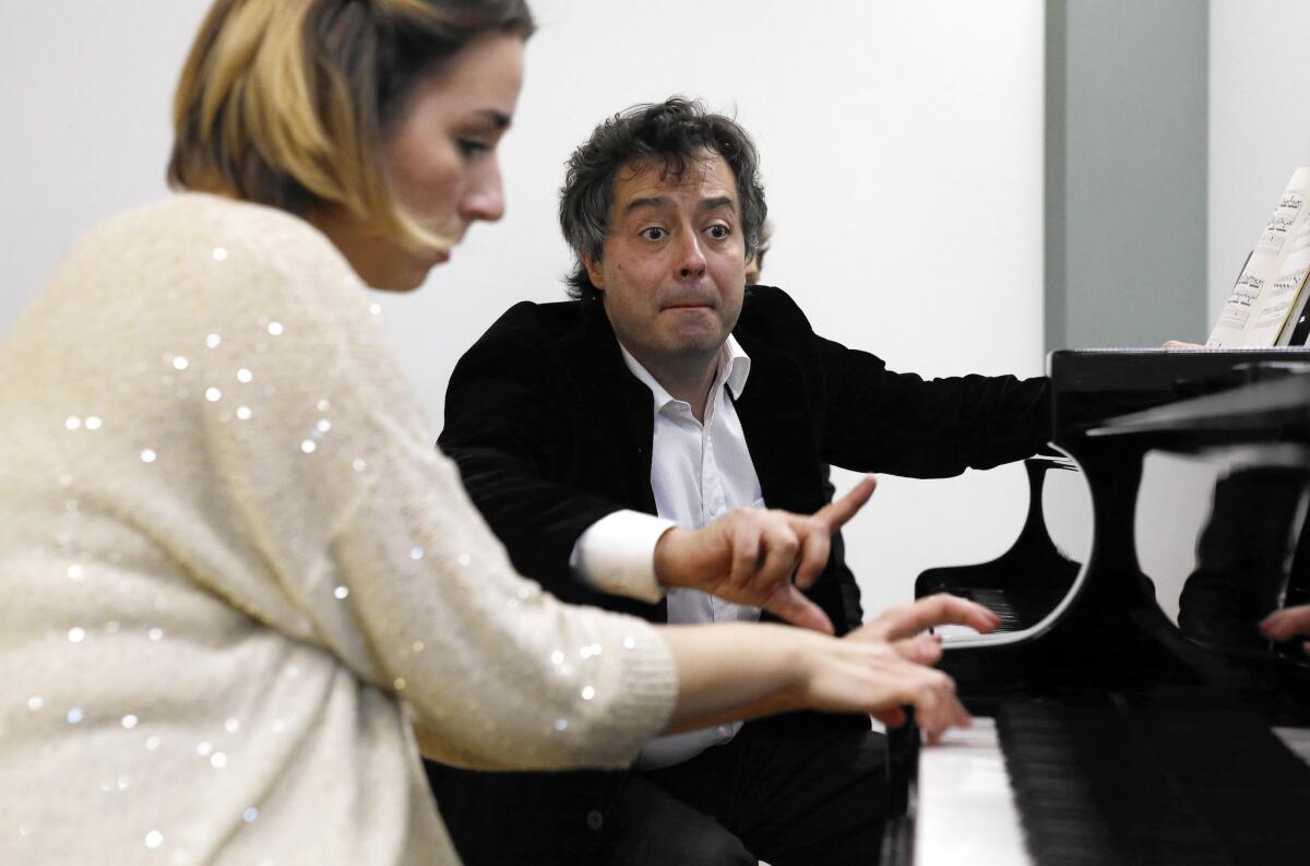 Fabio Bidini instructs Julijana Mijalkovic as she plays in a room at the Colburn School.