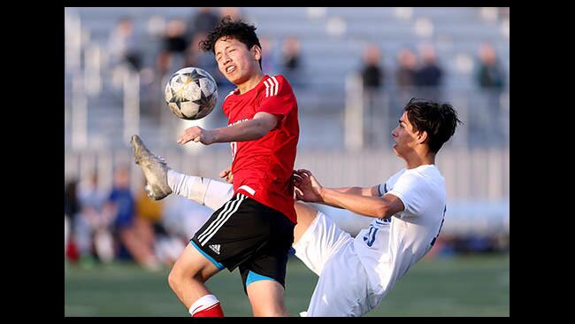 Burroughs High School soccer player #10 Esteban Alcantar battles for the ball with #10 Andy Cardenas in home game vs. Burbank High School, in Burbank ln Friday, Jan. 11, 2019.