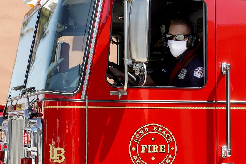 LONG BEACH, CALIF. - APR. 15, 2020. Firefighters respond to a call at Long Beach Fire Station 11 on Wednesday, Apr. 15, 2020. Eight firefighters at the station were tested for COVID-19. (Luis Sinco/Los Angeles Times)