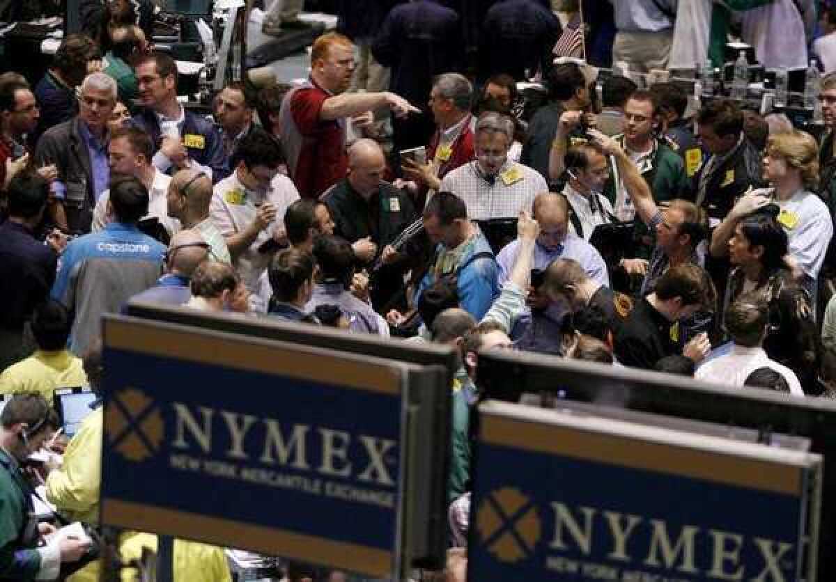 Crude oil future traders work on the floor of the New York Mercantile Exchange in New York.