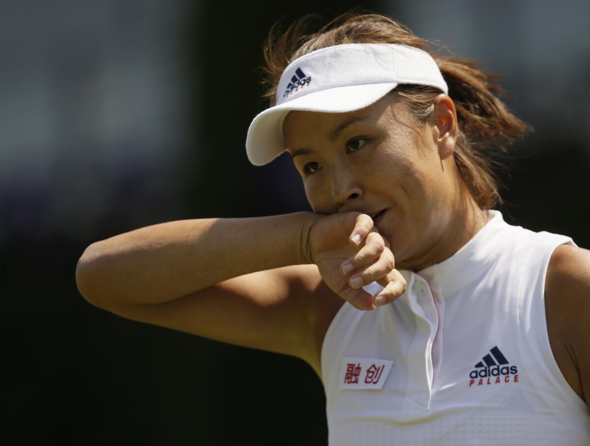 China's Peng Shuai holds the back of her hand to her mouth during a match
