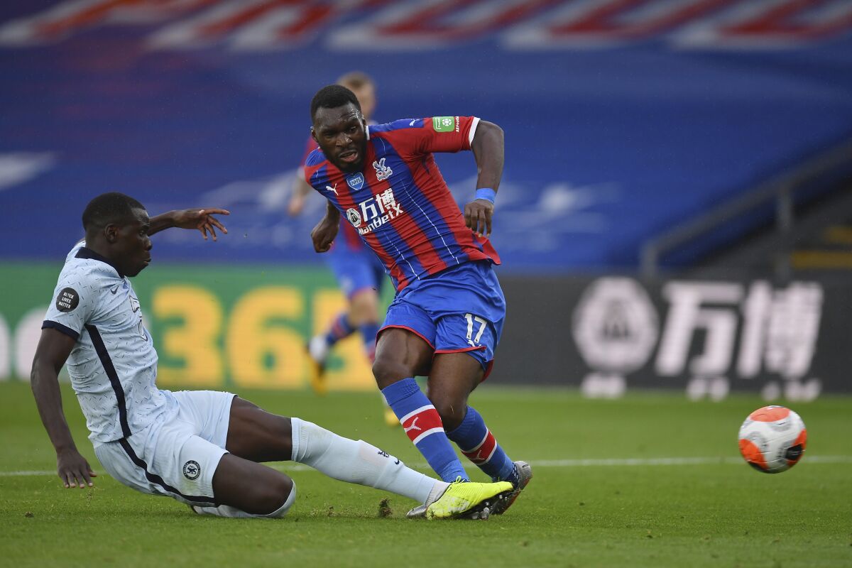 Crystal Palace's Christian Benteke, right, is tackled by Chelsea's Kurt Zouma during the English Premier League soccer match between Crystal Palace and Burnley at Selhurst Park, in London, England, Tuesday, July 7, 2020. (Justin Setterfield/Pool via AP)
