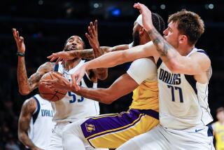 Lakers forward Anthony Davis battles with Mavericks forward Derrick Jones Jr. and guard Luka Doncic 