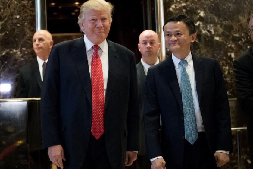 President-elect Donald Trump and Jack Ma, chairman of Alibaba Group, emerge from the elevators to speak to reporters following their meeting at Trump Tower.