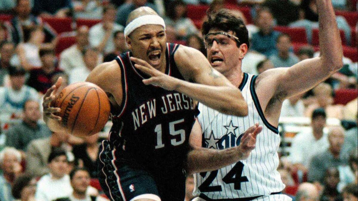 New Jersey Nets forward Chris Gatling, left, tries to drive past Orlando Magic center Dan Schayes during a game in April 1998.