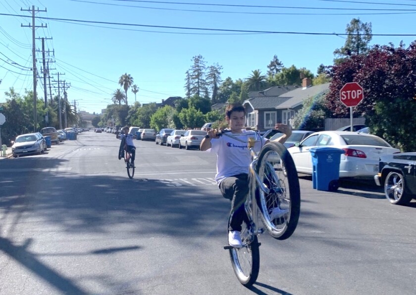 Javier Melendes, 15 (front) and Jesse Rivera, 13 ride their bikes down one of Redwood City's "Safe Streets."