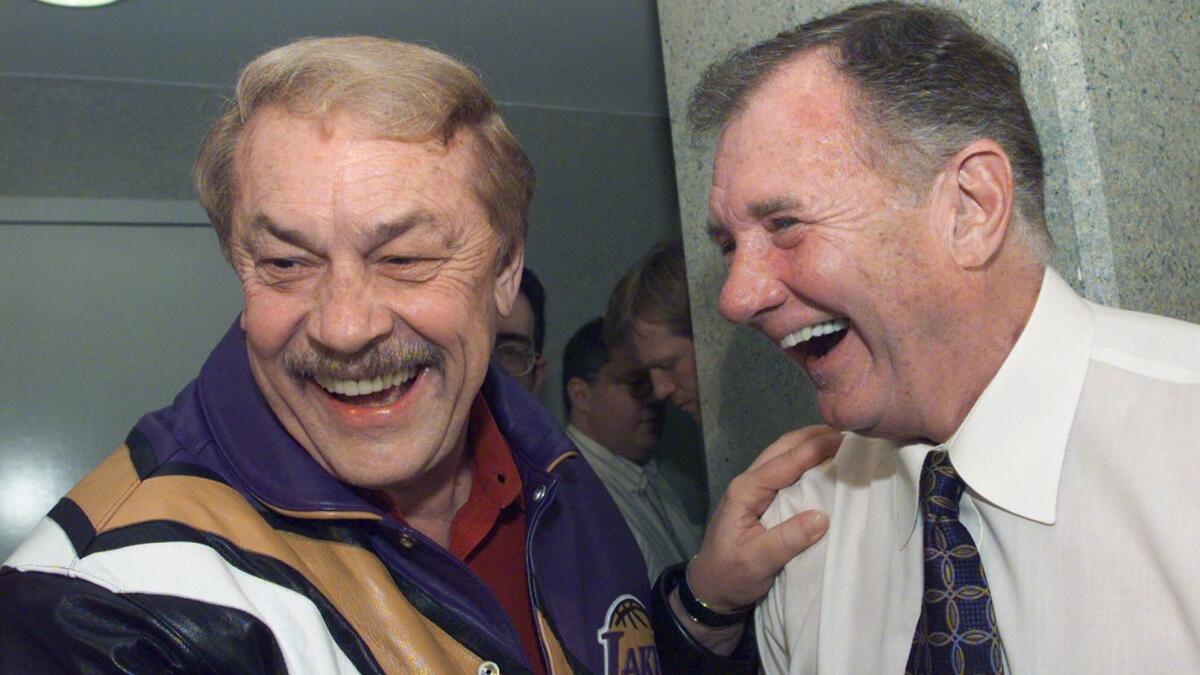 Lakers owner Dr. Jerry Buss, left, jokes with interim head coach Bill Bertka following the Lakers' 115-100 victory over the Clippers at Arrowhead Pond in Anaheim on Feb. 26, 1999.