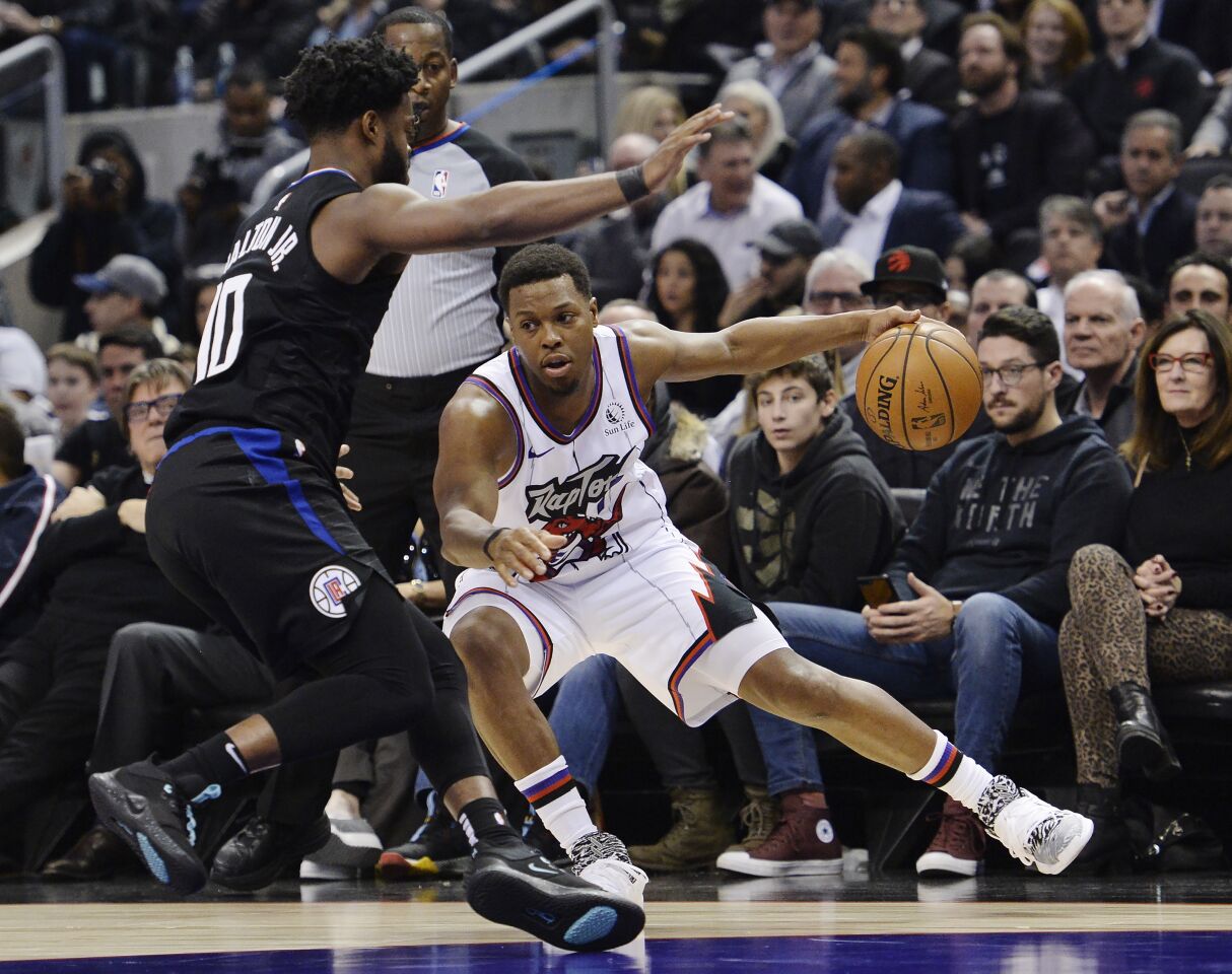 Raptors guard Kyle Lowry (7) is defended by Clippers guard Derrick Walton Jr. (10) during the first half of a game Dec. 11.