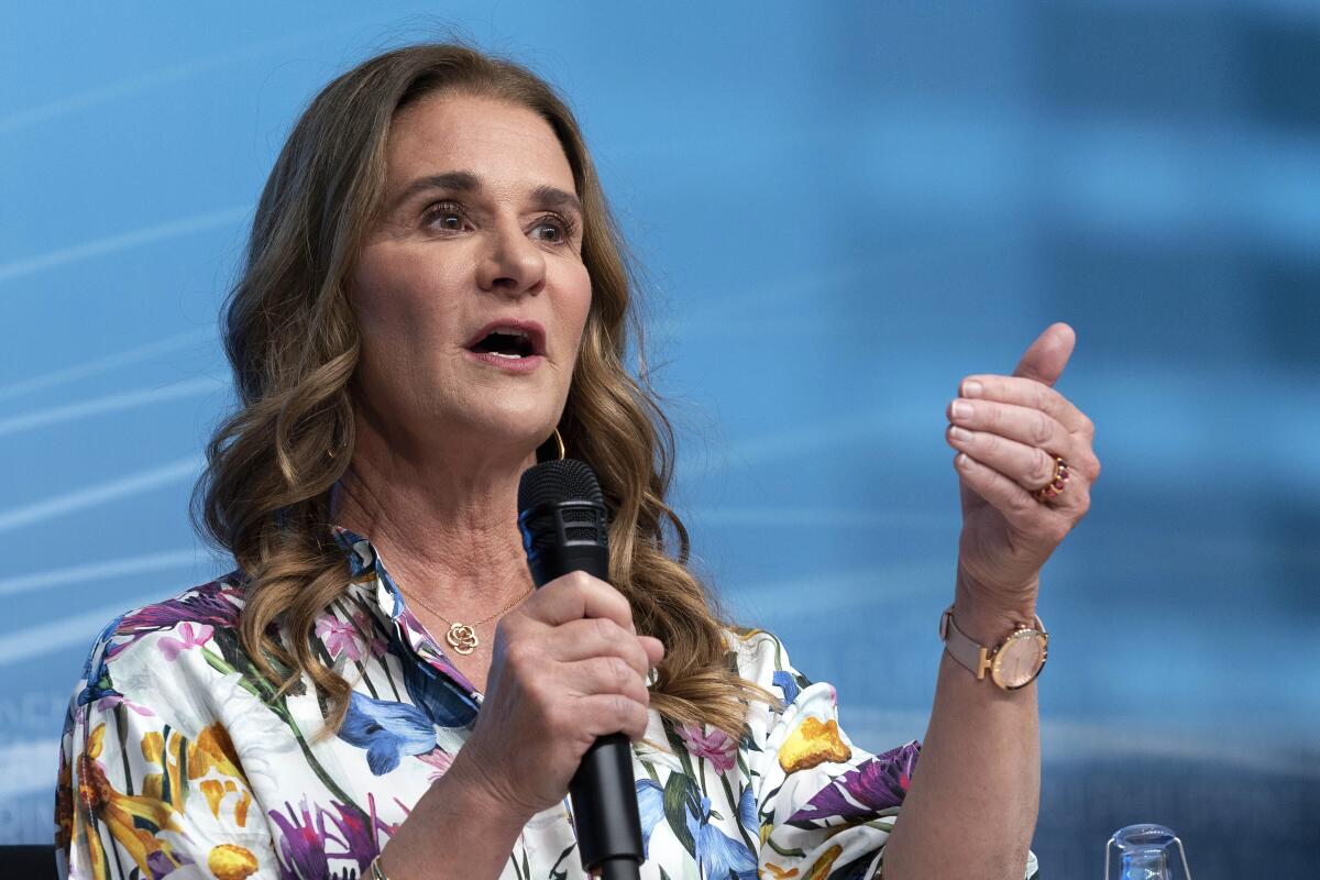 Melinda French Gates speaks holding a microphone.