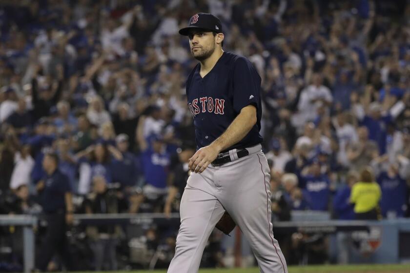 Boston Red Sox pitcher Nathan Eovaldi walks off the field after giving up a walk off home run to Los Angeles Dodgers' Max Muncy during the 18th inning in Game 3 of the World Series baseball game to defeat the Boston Red Sox 3-2 on Saturday, Oct. 27, 2018, in Los Angeles. (AP Photo/David J. Phillip)