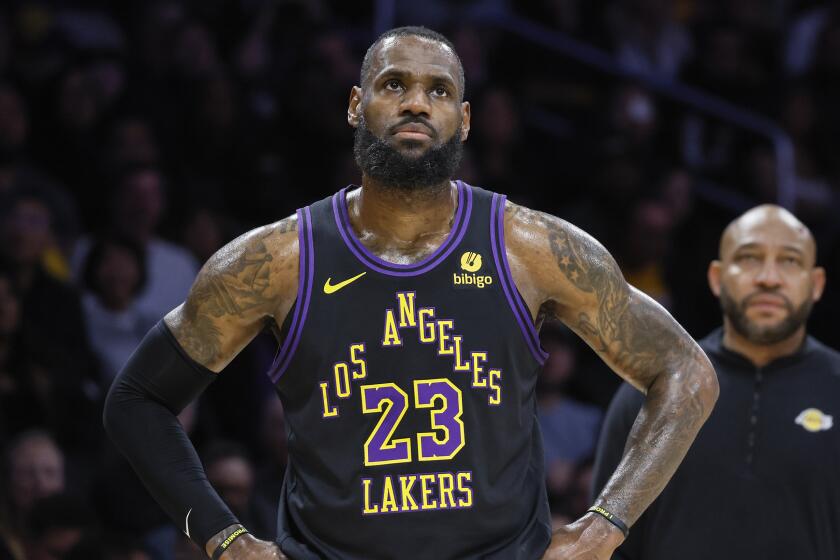 Lakers star LeBron James looks up while standing on the court.