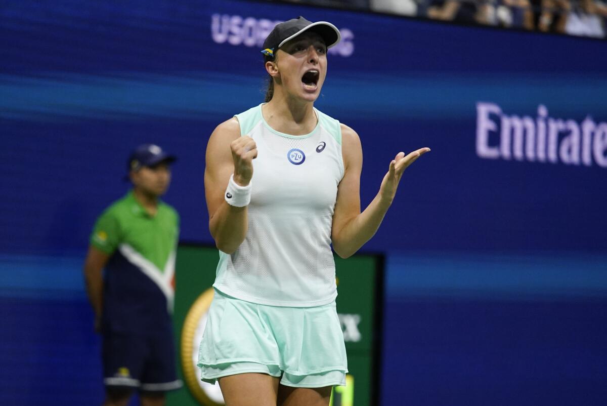 Iga Swiatek, of Poland, reacts after defeating Aryna Sabalenka, of Belarus.