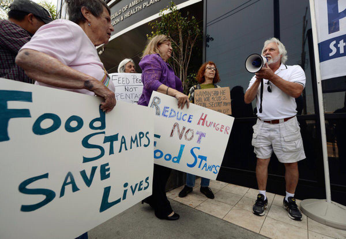 Tom Camarello of Progressive Democrats of America and other activists rally in Los Angeles on Monday to urge Rep. Henry Waxman (D-Beverly Hills) to oppose a House farm bill that would reduce spending on food stamps and other services for the poor.