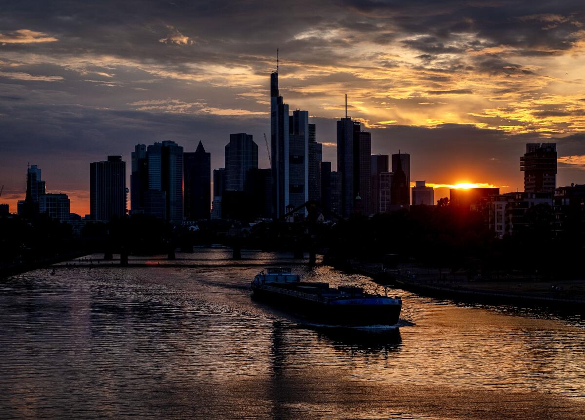 A cargo vessel cruises on the river Main in Frankfurt, Germany