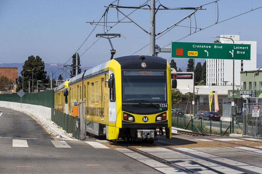 LOS ANGELES, CA -AUGUST 22, 2022:A metro train, traveling on the new K Line, makes its way along Crenshaw Blvd. in Los Angeles, during a test run. Metro's K Line (Crenshaw/LAX Transit Project) will extend light rail from the existing Metro E Line (Expo) at Crenshaw and Exposition Boulevards to the Metro C Line. While the rail line includes 8 new stations, only 7 will be open in the fall of 2022. The train will travel 8.5 miles and will serve the cities of Los Angeles, Inglewood, and El Segundo and portions of unincorporated Los Angeles County. (Mel Melcon / Los Angeles Times)