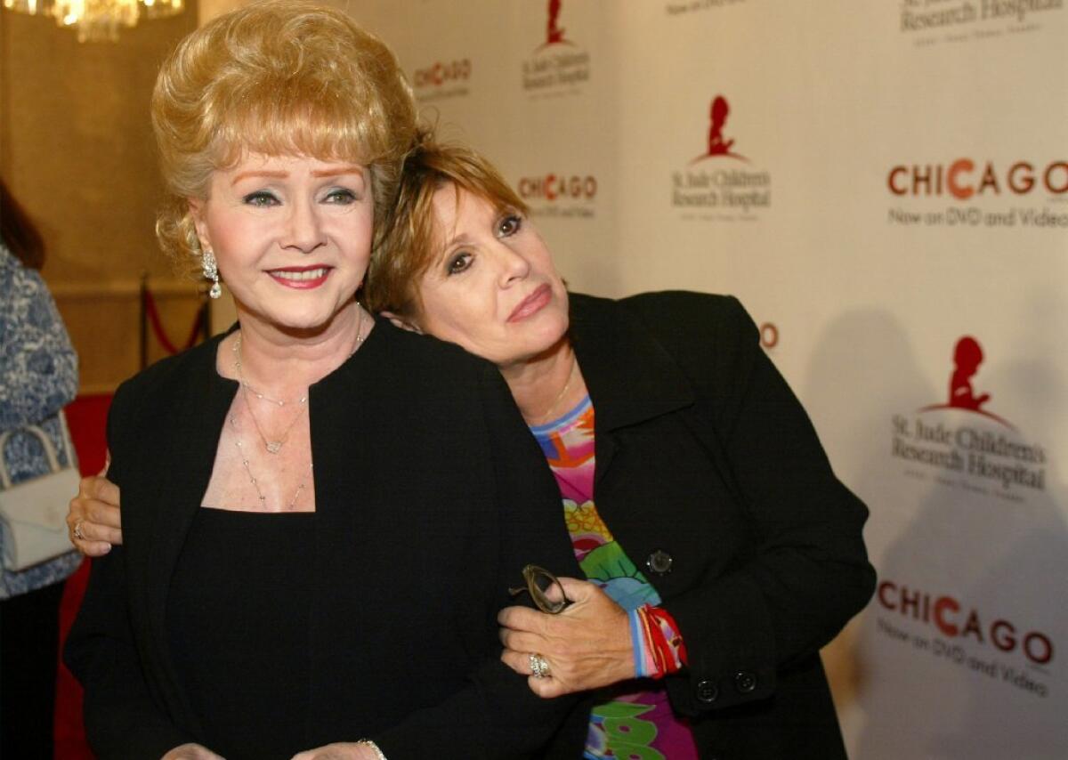 In this 2003 file photo, Debbie Reynolds and Carrie Fisher arrive at a fundraiser in Beverly Hills.