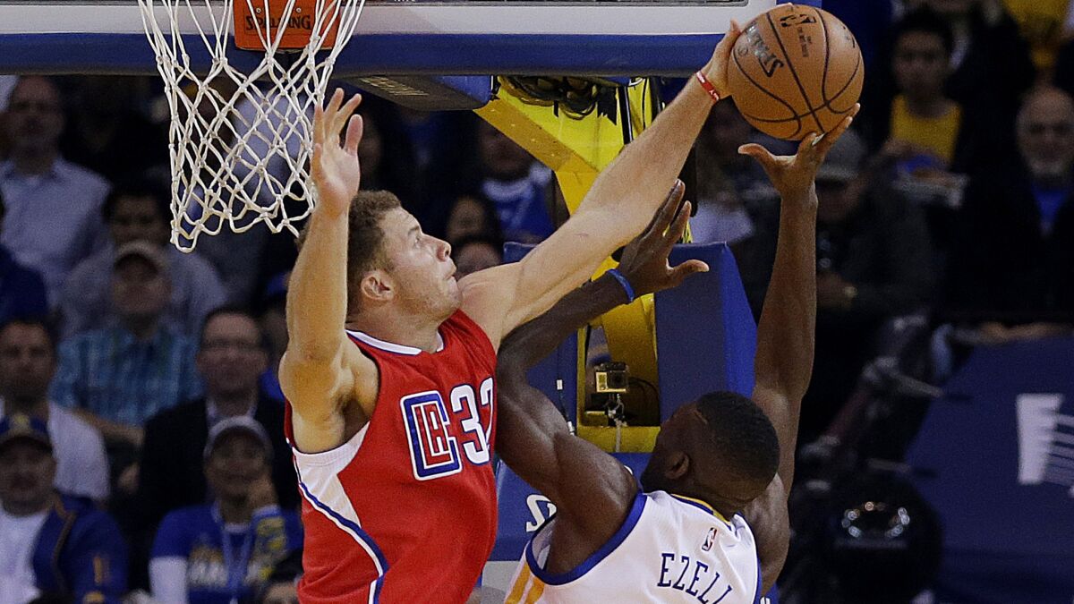 Clippers forward Blake Griffin blocks a shot by Warriors center Festus Ezeli in the first half.