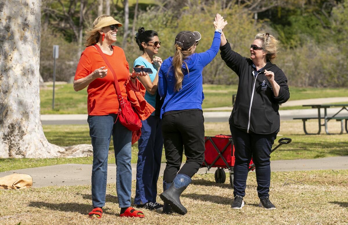 Dr. Elizabeth Wood and Debbie McGuire high five.