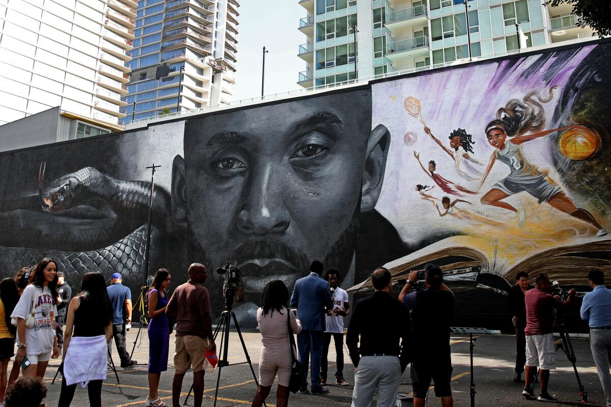 A mural honoring Kobe Bryant and daughter Gianna is unveiled at West Coast Trial Lawyers' offices in downtown L.A.