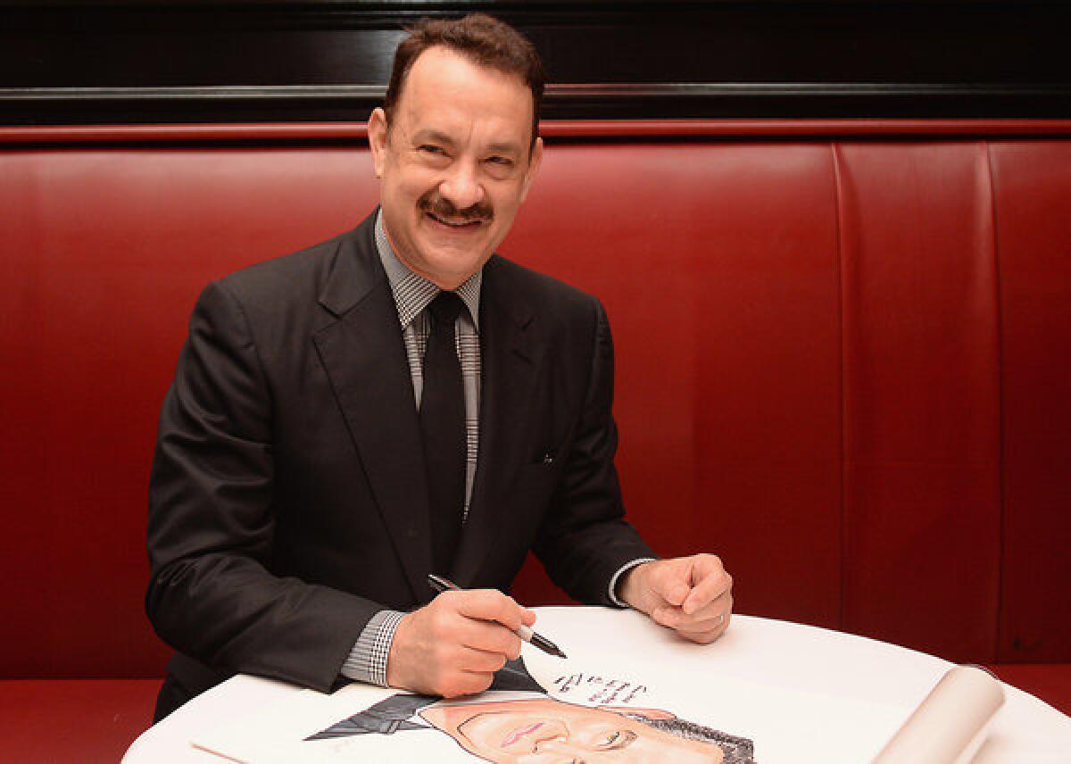 Actor Tom Hanks, shown here at an unveiling of his caricature at Sardi's last month, will play Walt Disney in an upcoming movie.