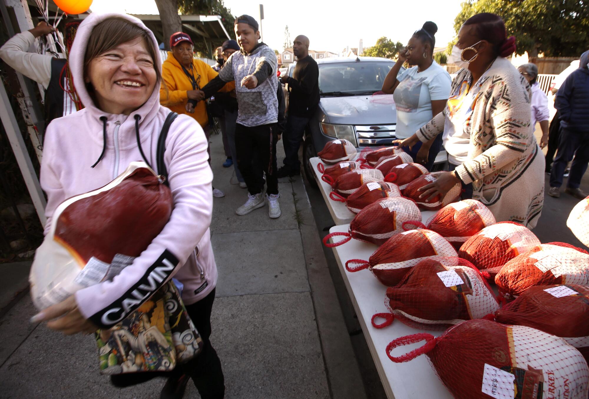 A woman gets a turkey at a Parents of Watts event, which provided Thanksgiving meals to families.