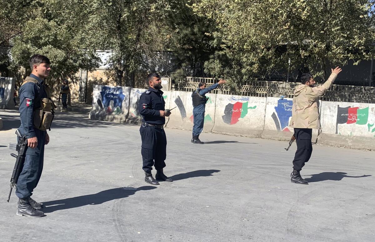 Afghan police arrive at the site of an attack at Kabul University in Kabul, Afghanistan.