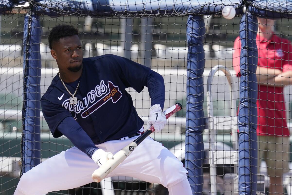 Atlanta Braves outfielder Ronald Acu?a Jr. eyes a bunt during spring training batting practice.