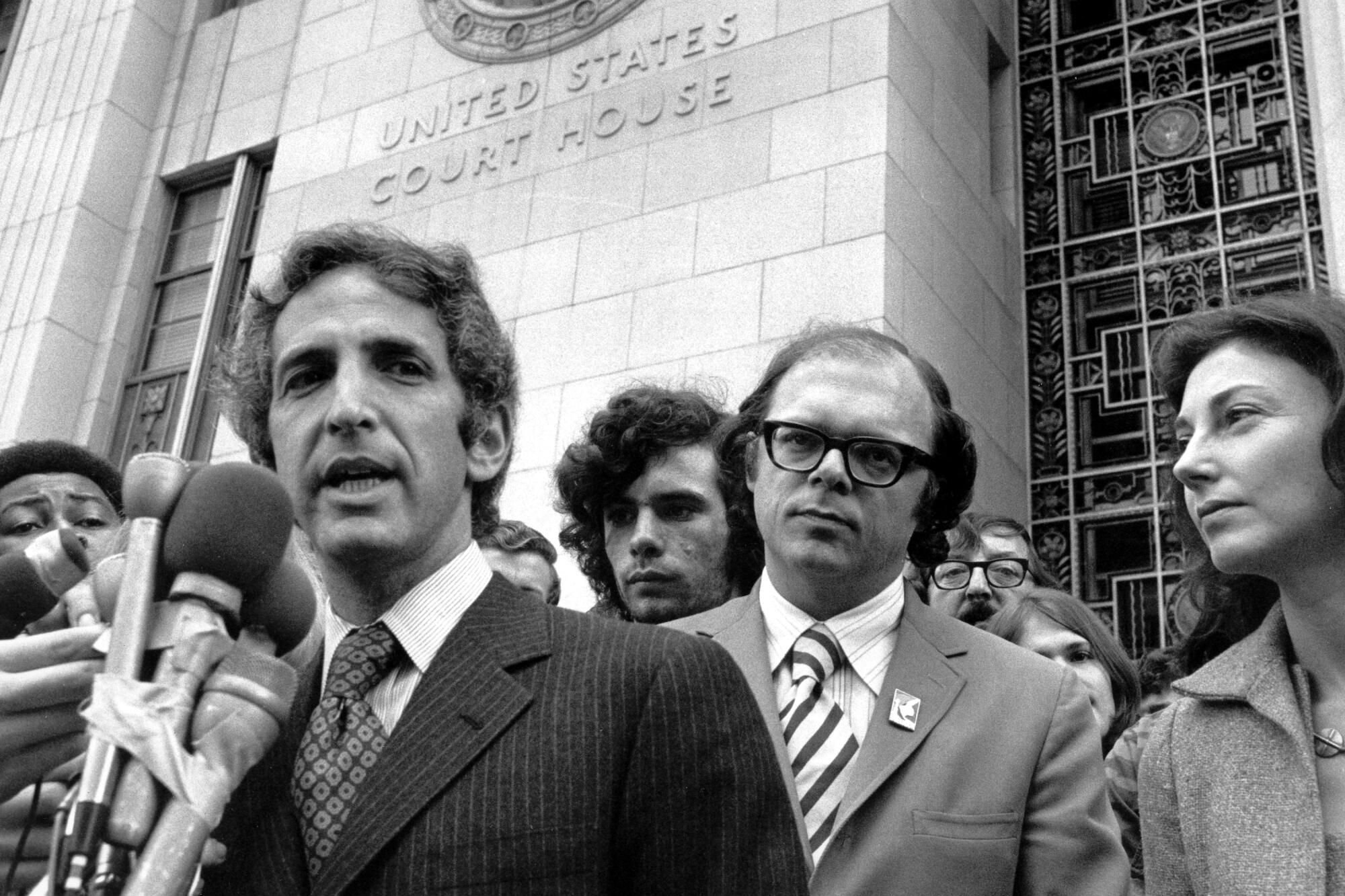 Daniel Ellsberg, left, addresses the media outside the Federal Building in L.A. in 1973 during the Pentagon Papers trial.