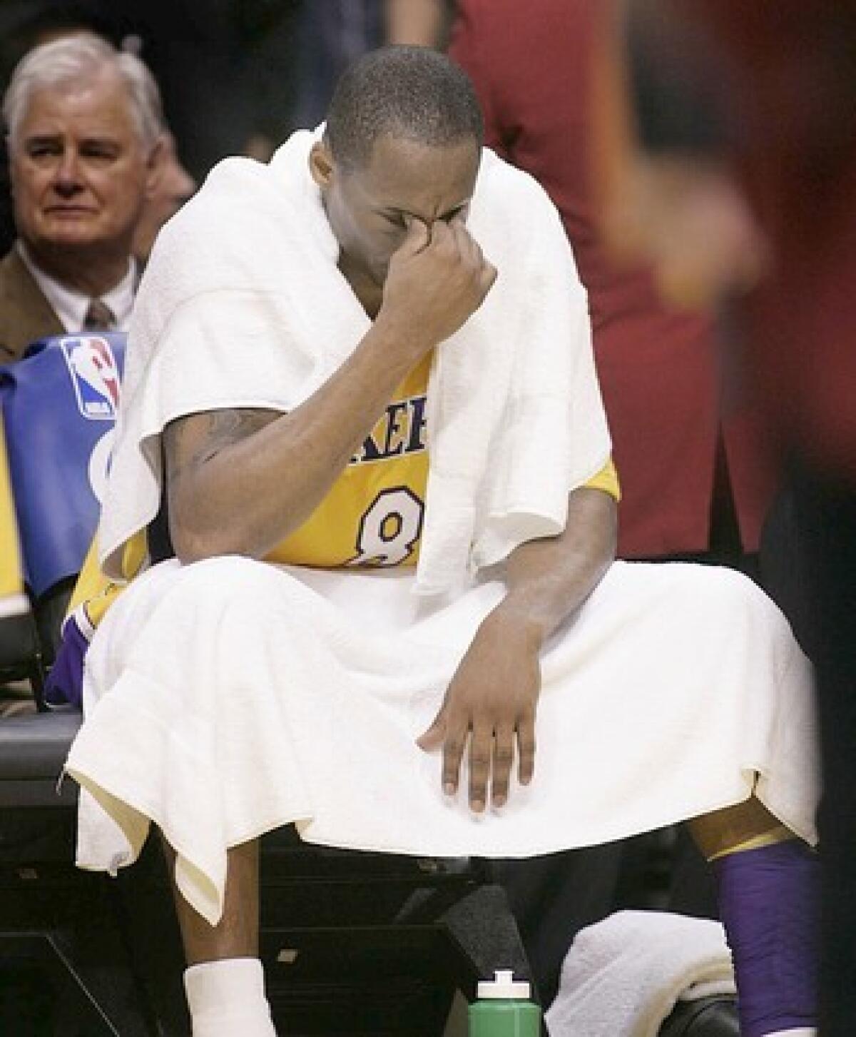 Kobe Bryant sits on the bench during a Lakers overtime loss to the Phoenix Suns.